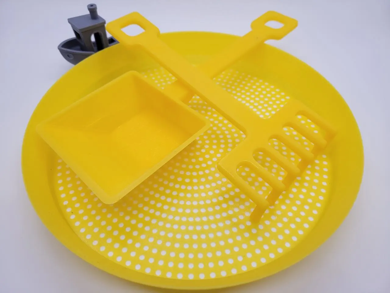 A render of 3d printed sand rake, sifter, and shovel