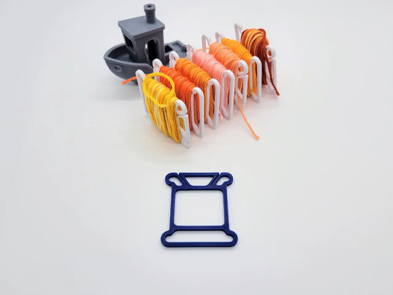 A render of a 3d printed minimalist floss bobbin