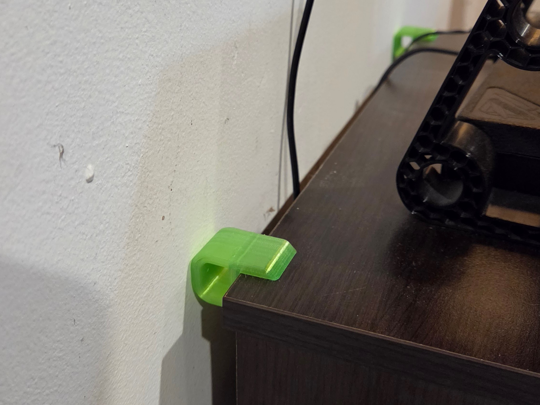 A 3D printed TPU slip on anti-rattle bumper keeping a drawer from scratching a wall.