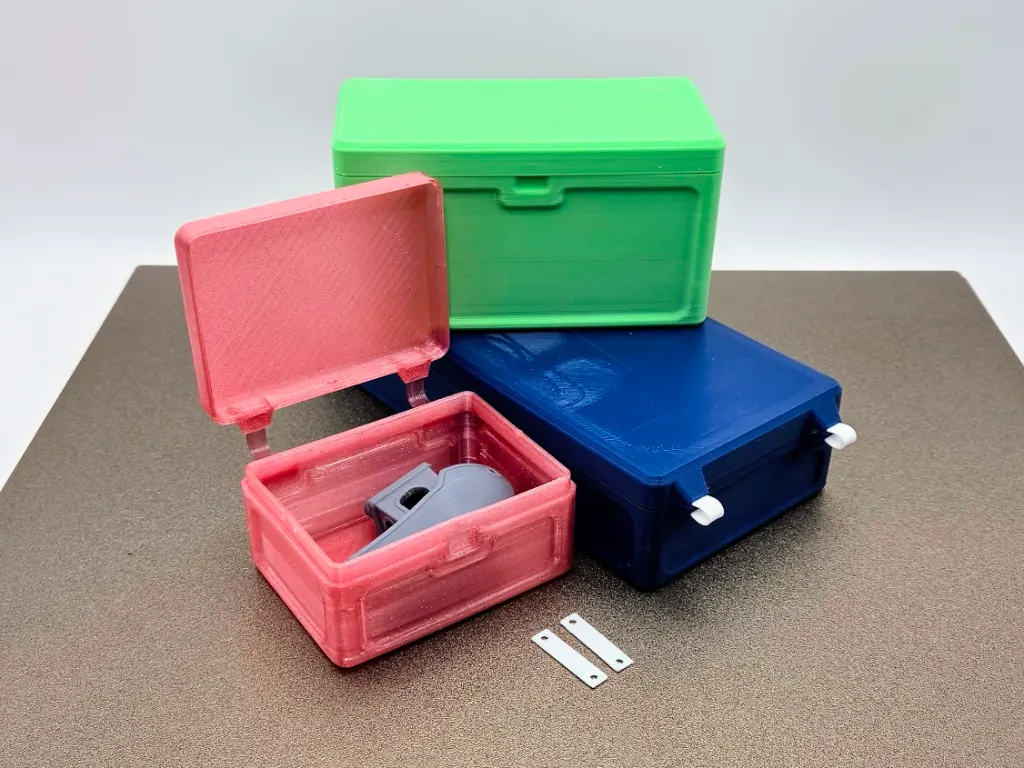 A product shot of several sizes of customizable 3D printed containers with a living TPU hinge.