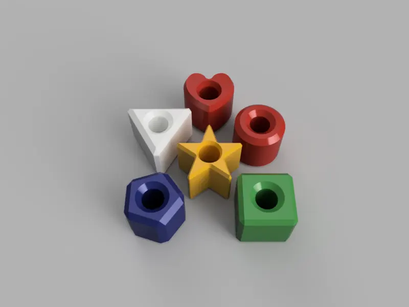 A render of several 3d printed geometrically shaped beads for teaching children to thread